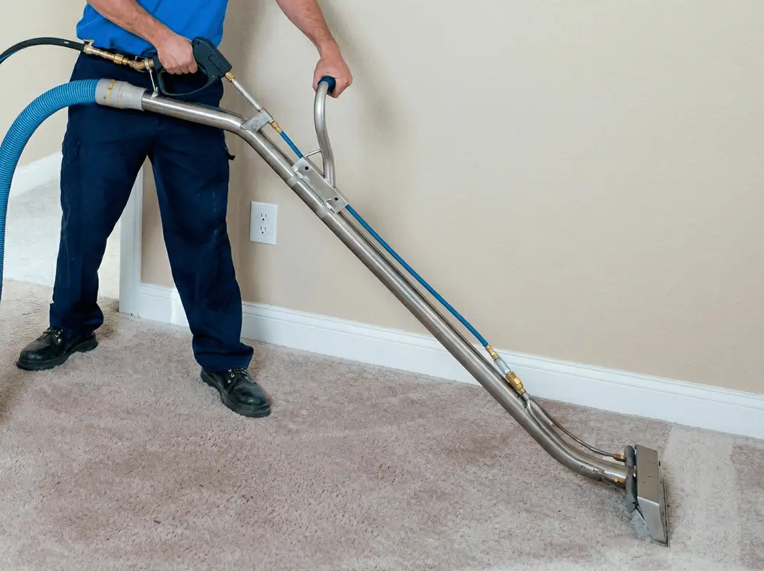 Professional operating a liquid removal machine on a carpeted floor in Baltimore, MD